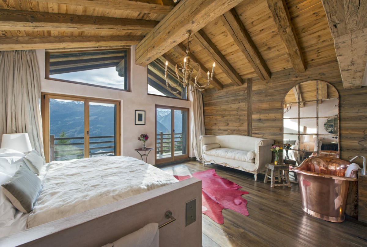 Chalet 1936, Verbier – the bedrooms are quite simply stunning. From antique wood beams to roll top copper baths, natural stone sinks and sumptuous fabrics, every detail oozes luxury with a quirky twist