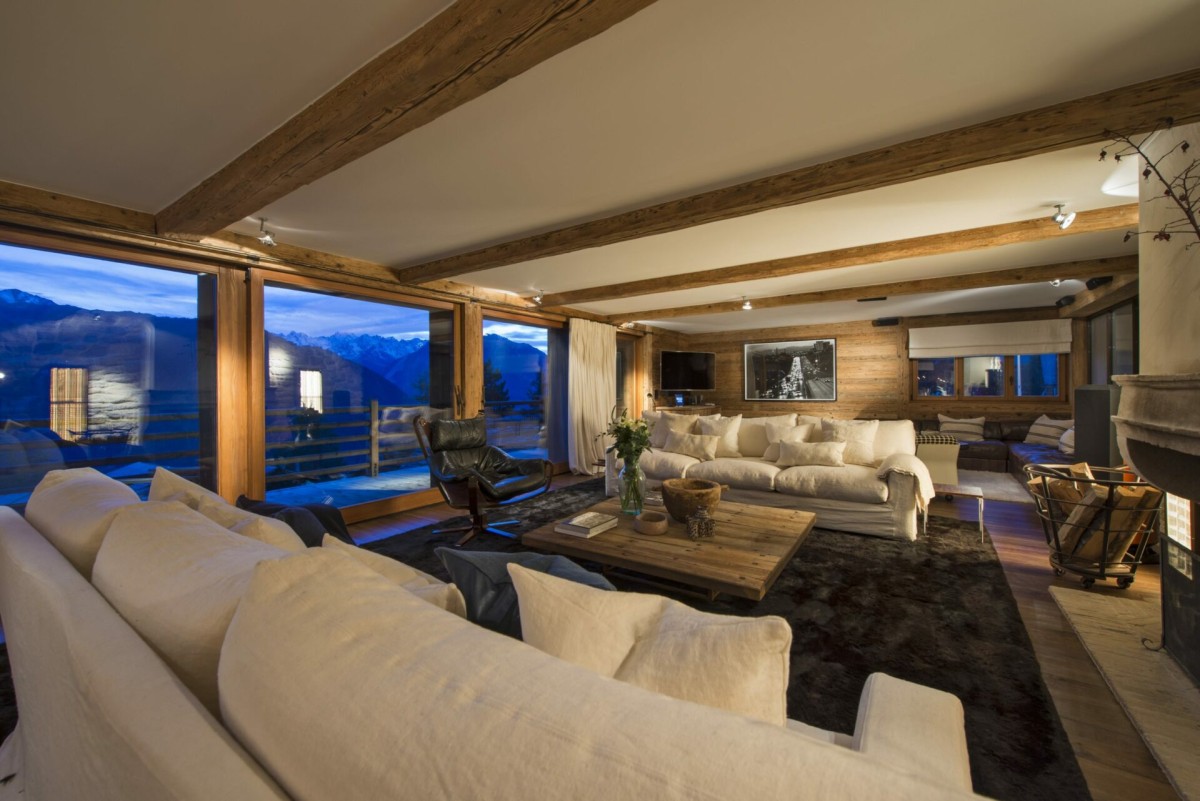 Chalet 1936, Verbier – the living room offers plenty of space for everyone to relax. Full height sliding glass doors open onto the surrounding terrace