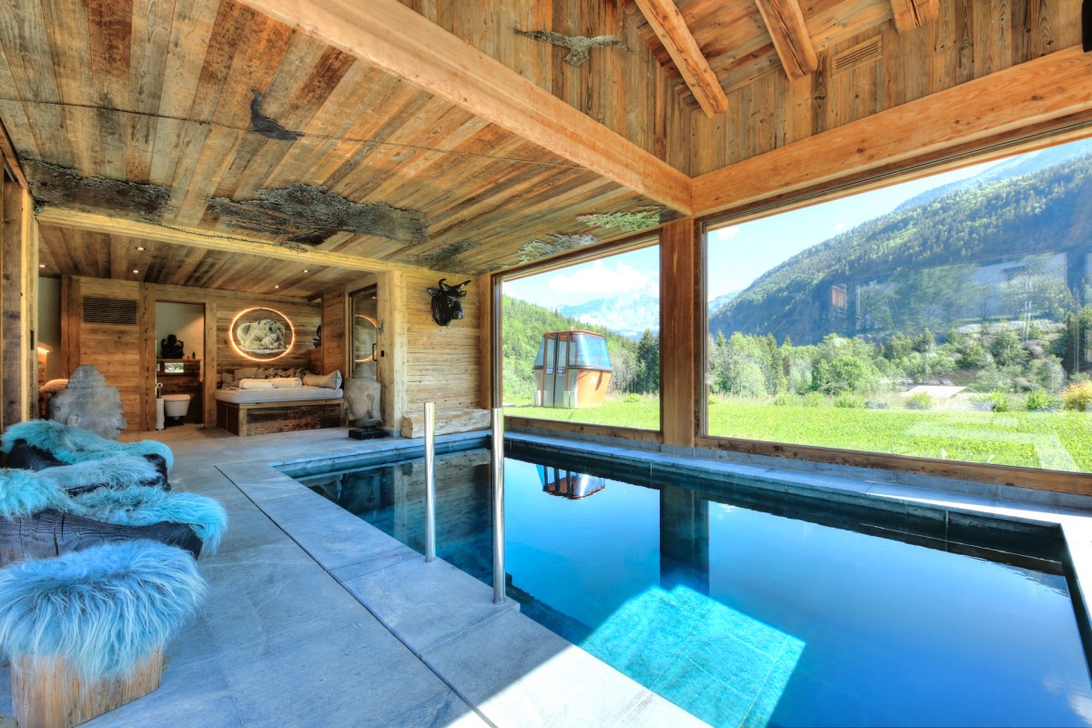 The indoor swimming pool of Chalet Des Cristaux on the ground floor. The chalet also comes with a sauna set up in an independent small chalet in the garden