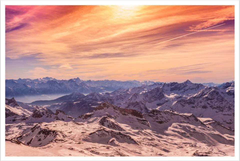 Sunset over snow covered mountains in the Cervinia skiing area in the Aosta Valley, Italys smallest and least populated region