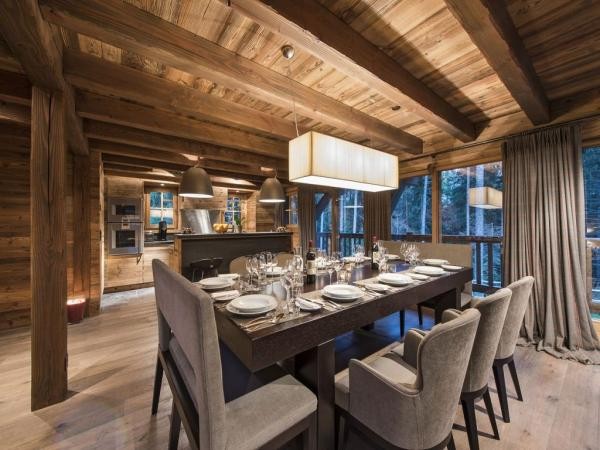 Dining table and open kitchen at Chalet du Bonheur Dining table and open kitchen at Chalet du Bonheur
