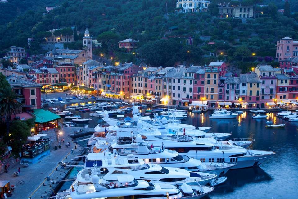 Yachts in the harbor of Portofino at the Riviera di Levante; the picturesque tiny coastal town is one of the most exclusive holiday resorts in Italy