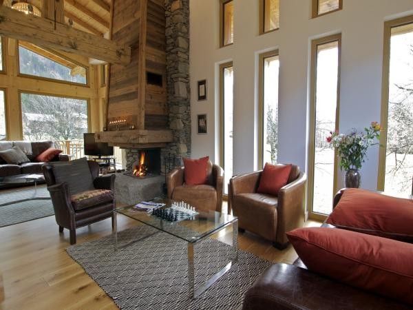 The the open fireplace in Chalet Colorado’s main living room provides a cozy atmospherePlease take note of our Pre-Xmas and Xmas availability in Val d’Isère and Méribel. Hurry up, only few luxury Chalets left!!!