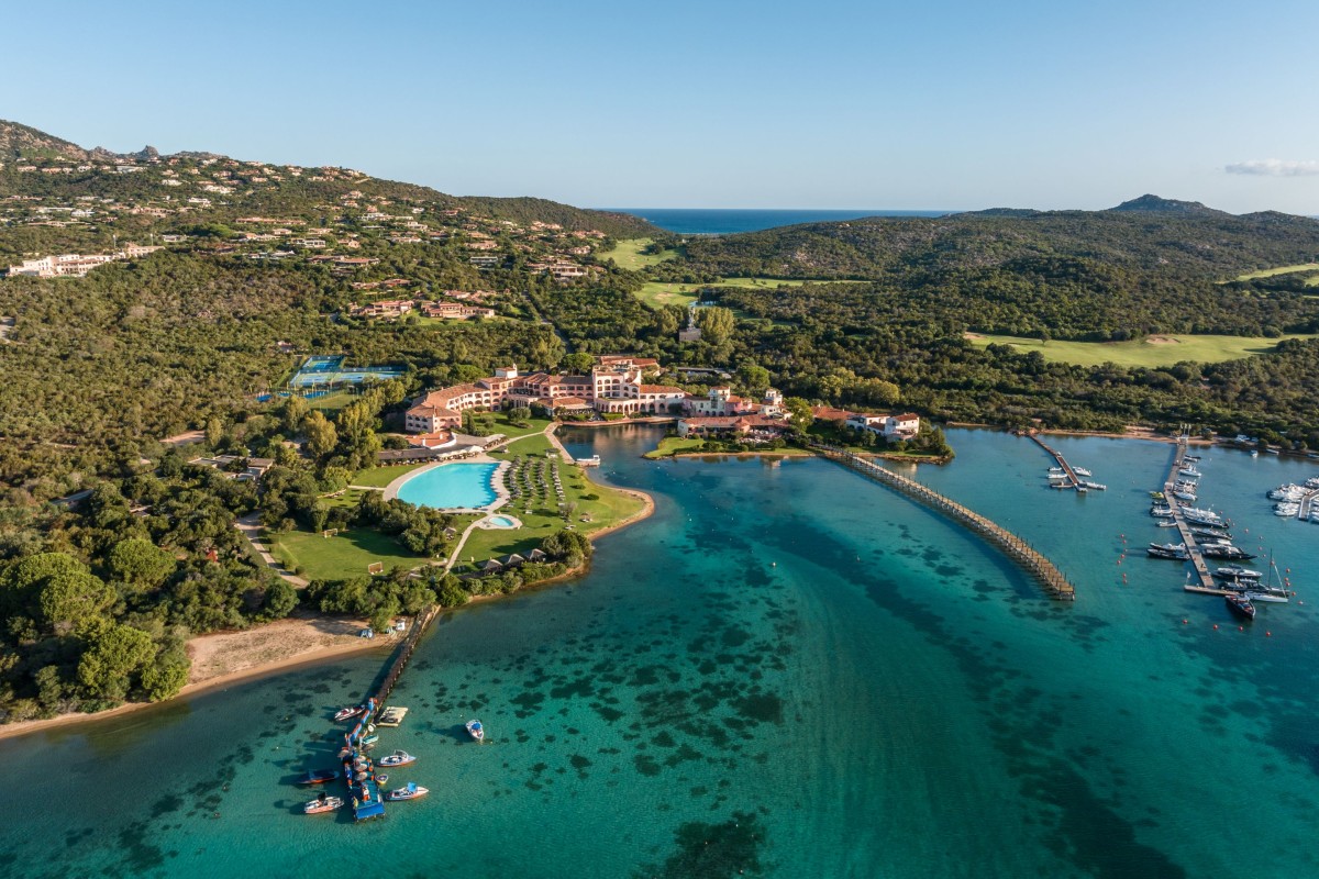 Hotel Cala di Volpe: A secluded haven with terracotta rooftops, turrets, and porticoes, adorned with cascading bougainvillea by architect Jacques Couëlle.